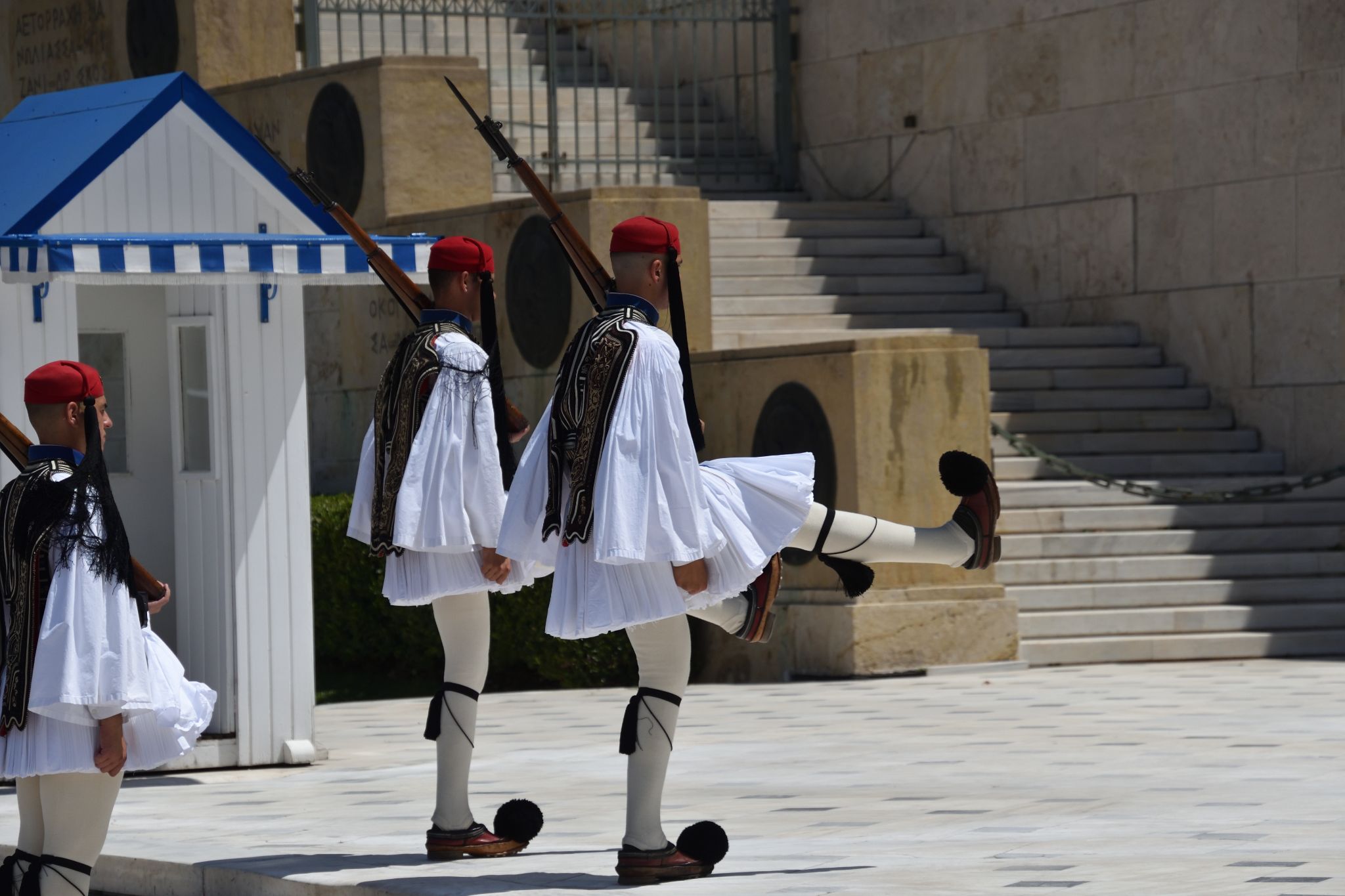 Greek national guards (Evzones) in front of the Tomb of the Unknown Soldier near building of Parliament